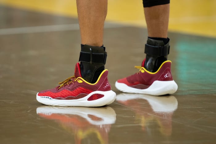 Golden State Warriors guard Stephen Curry's red and gold Under Armour sneakers.